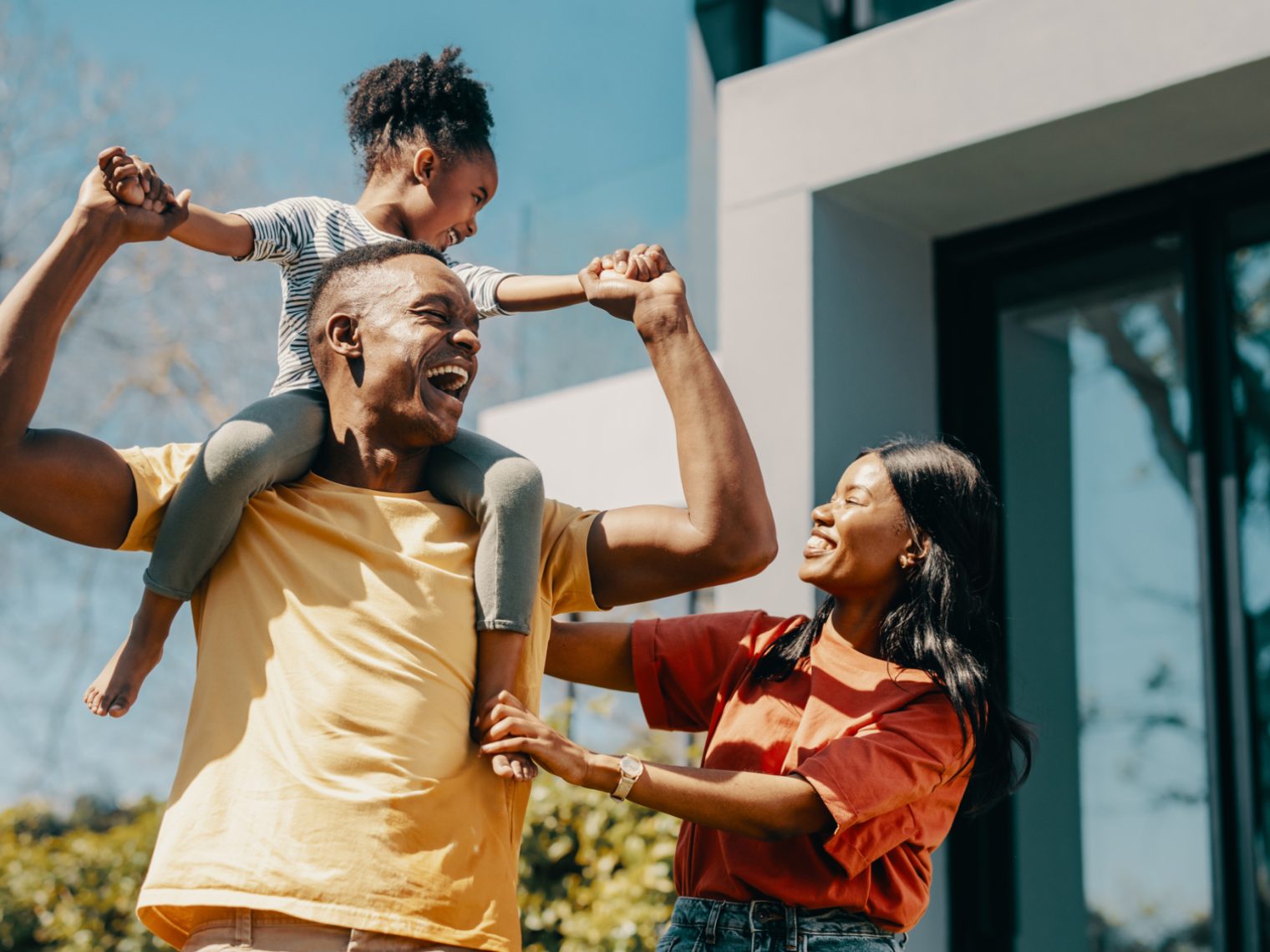 African American family outside their new home.