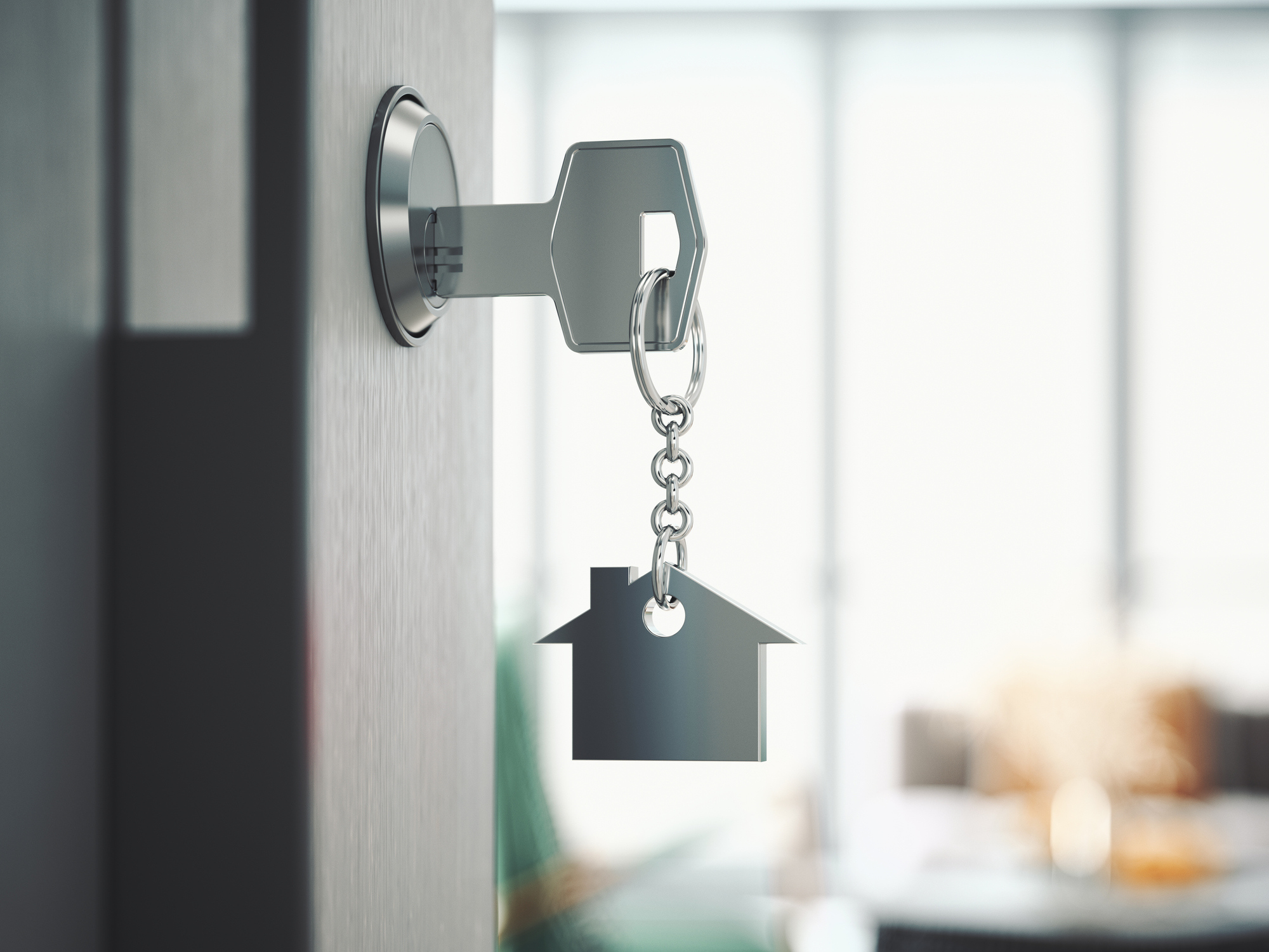 A key in a lock with a house shaped chain.