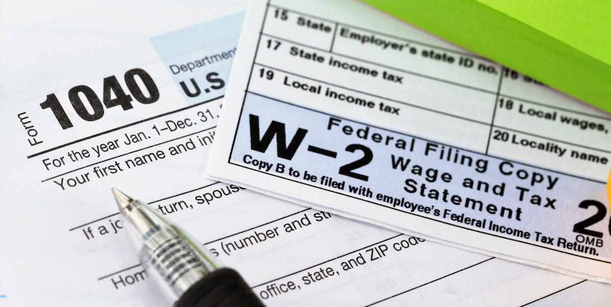 A picture of W2 tax form with a pen.